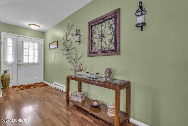 doorway with baseboard heating and hardwood / wood-style flooring