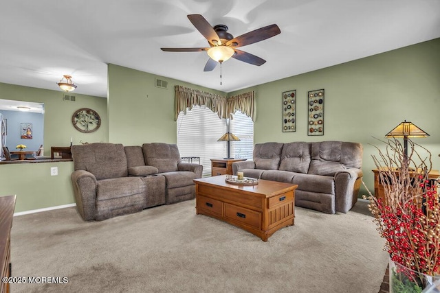 carpeted living room with ceiling fan