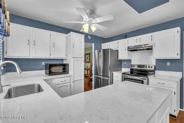 kitchen featuring light stone countertops, white cabinetry, appliances with stainless steel finishes, and sink