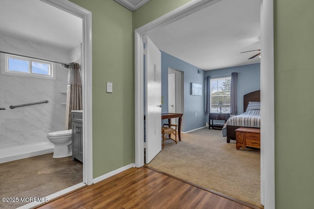 bedroom featuring wood-type flooring and connected bathroom