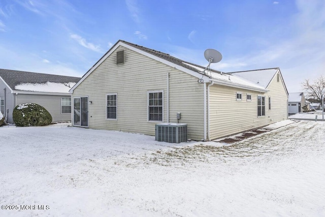 snow covered property featuring central air condition unit