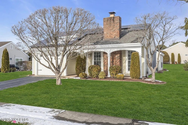 view of front of property with a garage and a front lawn