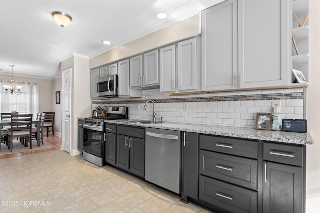 kitchen with sink, stainless steel appliances, and gray cabinetry