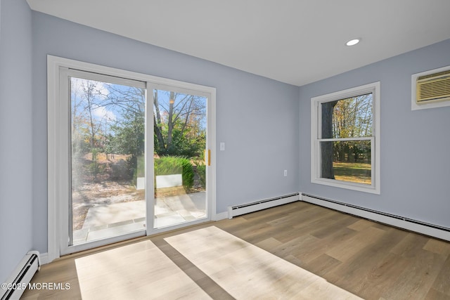 spare room with light hardwood / wood-style floors and a baseboard radiator