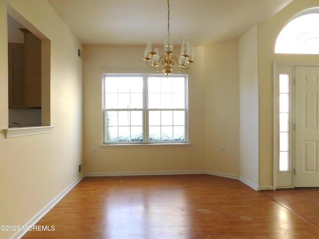 entryway with an inviting chandelier and light wood-type flooring