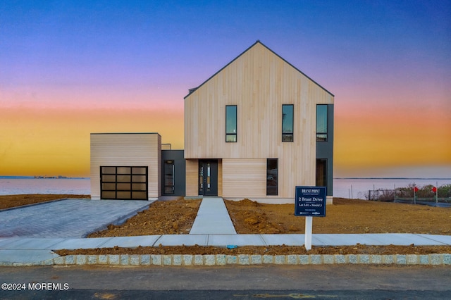 view of front of property featuring a water view and a garage