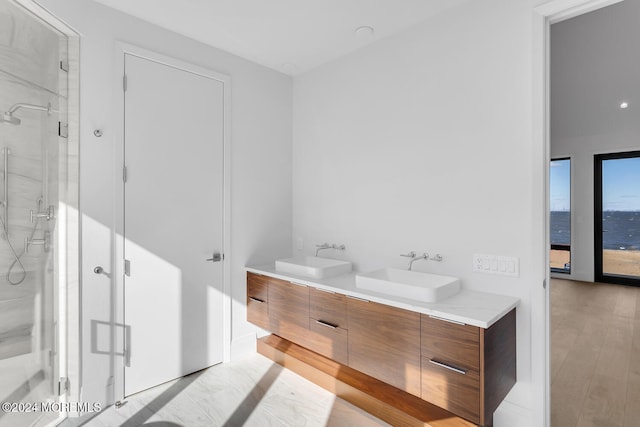 bathroom featuring a shower with shower door, wood-type flooring, and vanity