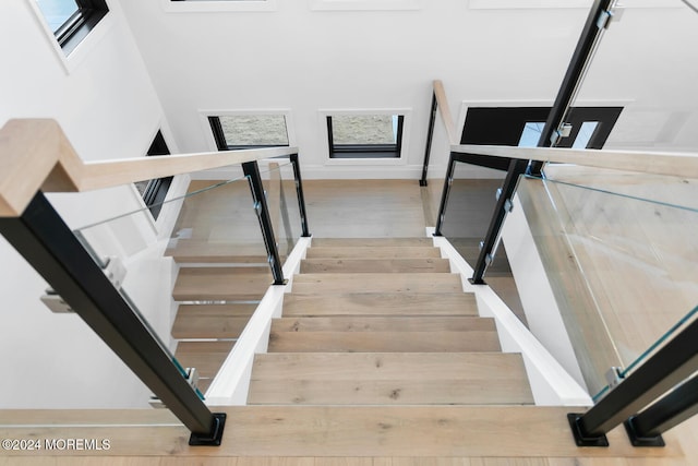 stairs featuring hardwood / wood-style floors