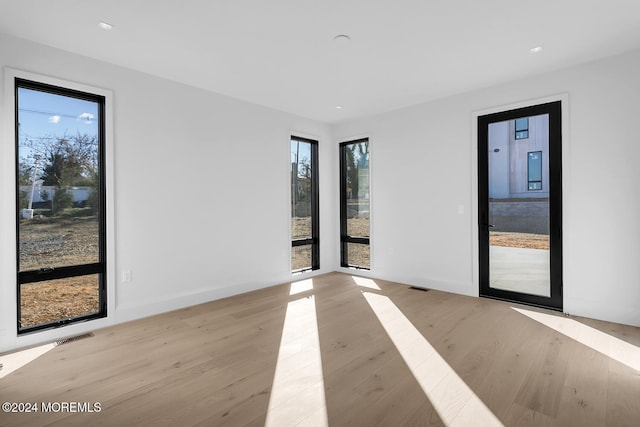 unfurnished room with light wood-type flooring