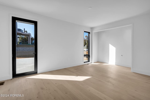 spare room with light hardwood / wood-style floors