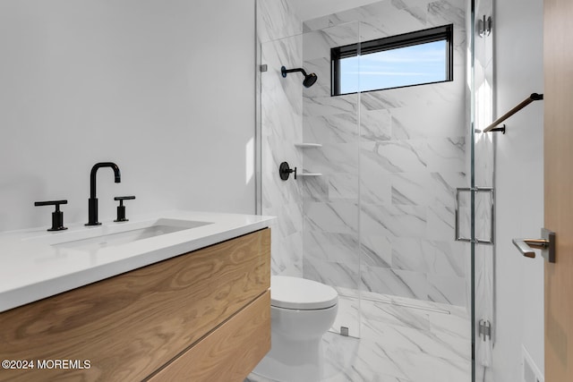 bathroom featuring tiled shower, toilet, and vanity