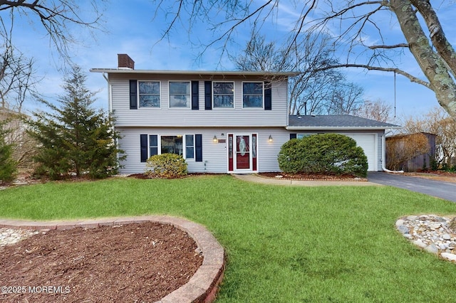 colonial home featuring a garage and a front yard