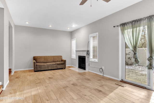 living room with ceiling fan and light hardwood / wood-style floors