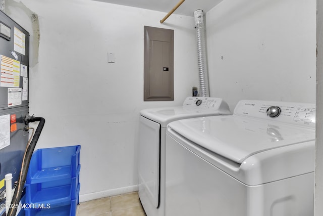 laundry room with washer and dryer, electric panel, and light tile patterned floors