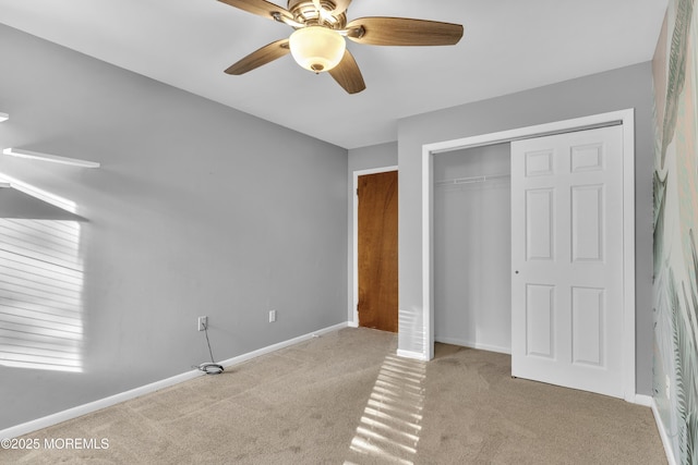 unfurnished bedroom with a closet, ceiling fan, and light colored carpet