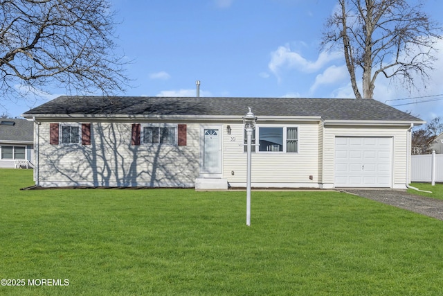 ranch-style home featuring a garage and a front yard