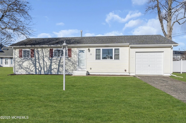 ranch-style home featuring a garage and a front lawn