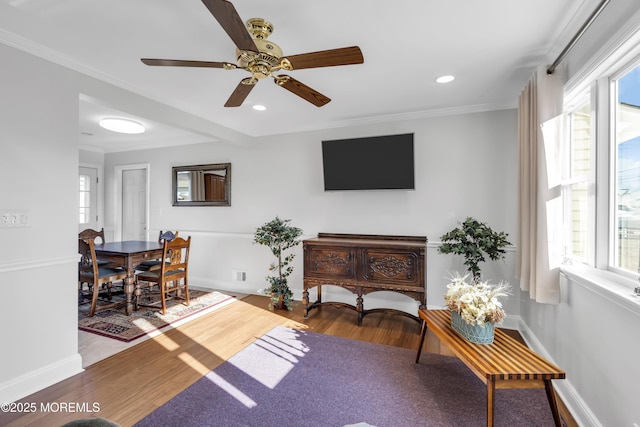 living room with wood-type flooring and ornamental molding