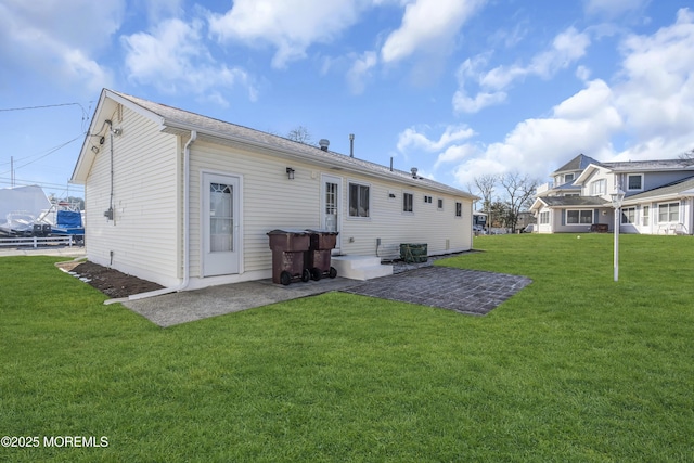 rear view of house with a patio area, a yard, and cooling unit