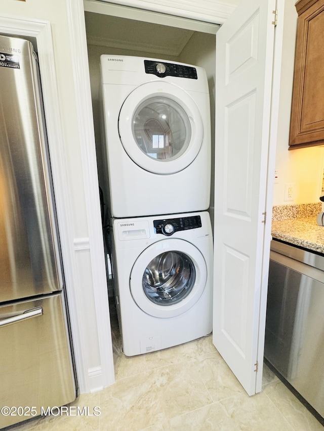 laundry area featuring stacked washer and clothes dryer