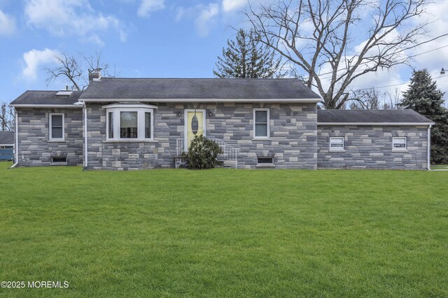 rear view of property with a lawn