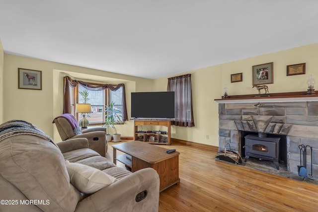 living room featuring light hardwood / wood-style flooring and a wood stove