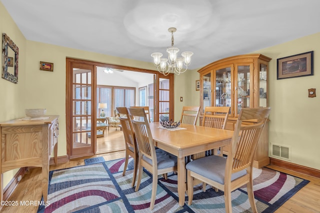 dining space with a chandelier and light wood-type flooring