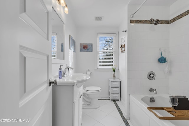 full bathroom with tiled shower / bath combo, toilet, tile patterned floors, and vanity