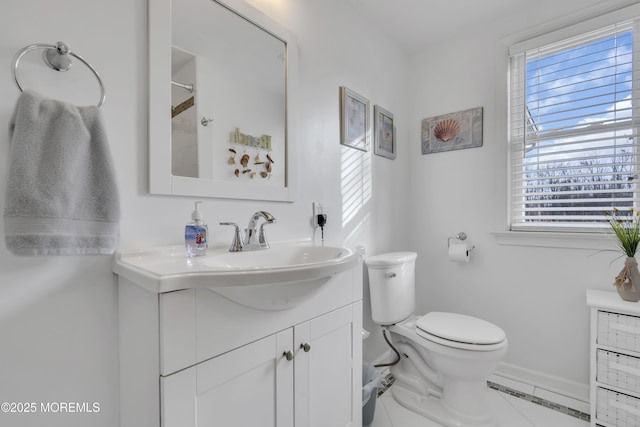 bathroom featuring vanity, toilet, tile patterned floors, and plenty of natural light