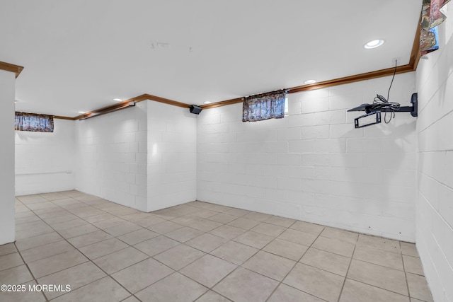 spare room featuring light tile patterned floors and ornamental molding