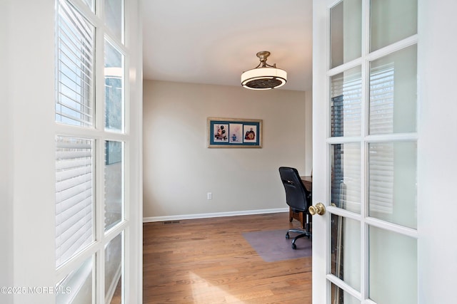 office area with wood-type flooring and french doors