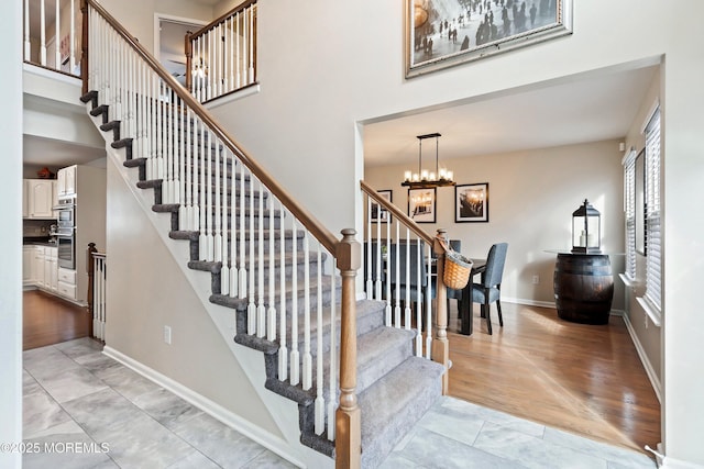 stairs featuring a chandelier and tile patterned floors