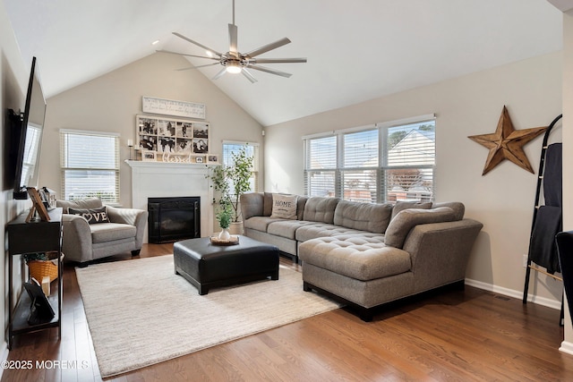 living room featuring ceiling fan, wood-type flooring, and lofted ceiling