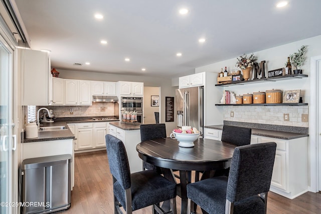 dining room with sink and dark hardwood / wood-style flooring