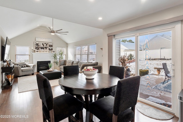 dining room with ceiling fan, hardwood / wood-style floors, and lofted ceiling