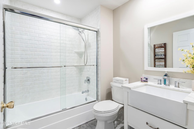 full bathroom with toilet, vanity, shower / bath combination with glass door, and tile patterned flooring