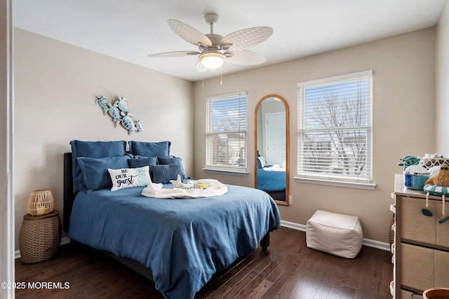 bedroom with ceiling fan and dark hardwood / wood-style floors