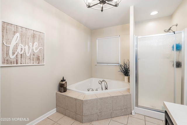 bathroom with a chandelier, tile patterned flooring, vanity, and shower with separate bathtub