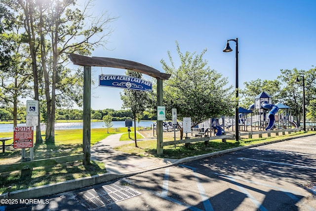 surrounding community with a playground and a water view