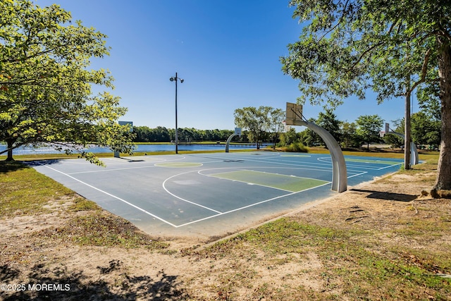 view of basketball court featuring a water view