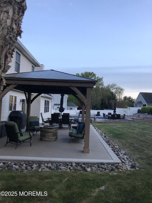 view of patio featuring an outdoor fire pit, a gazebo, and a grill