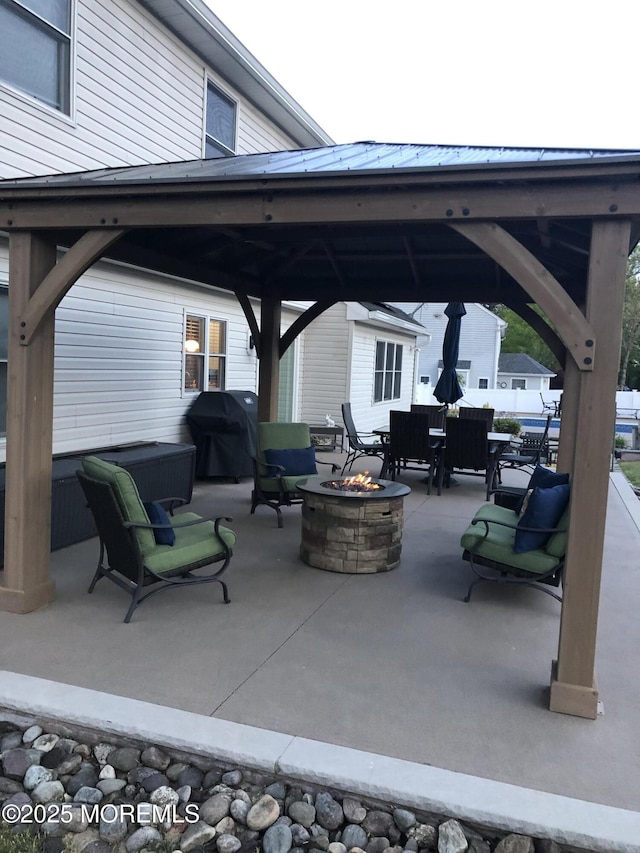 view of patio featuring a gazebo, a fire pit, and grilling area