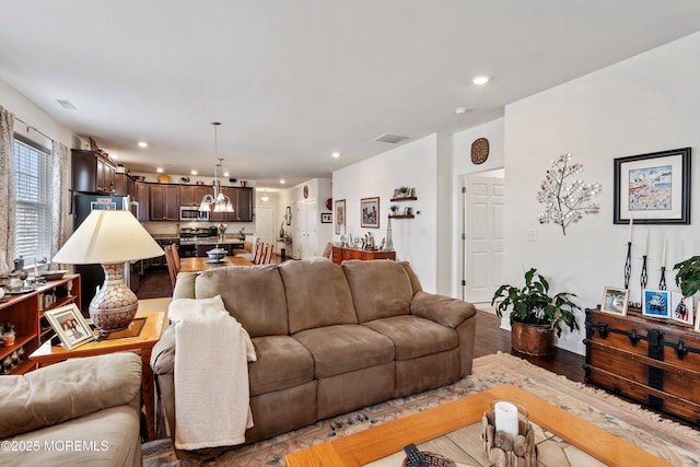 living room featuring hardwood / wood-style floors and an inviting chandelier