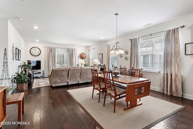 dining room with a chandelier and dark hardwood / wood-style flooring