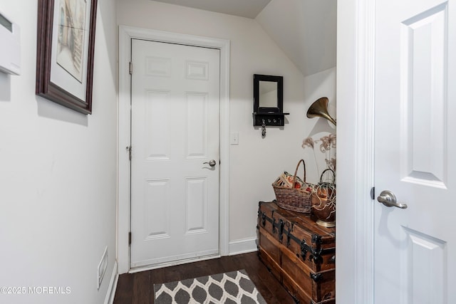 doorway to outside with dark wood-type flooring and lofted ceiling