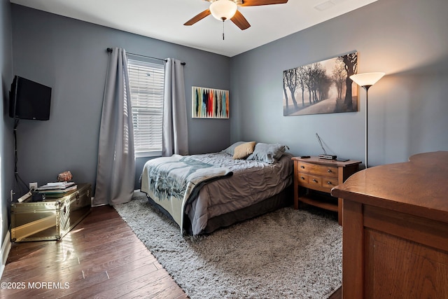 bedroom with ceiling fan and dark hardwood / wood-style flooring