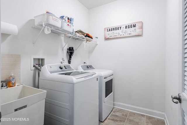 laundry area featuring sink and separate washer and dryer