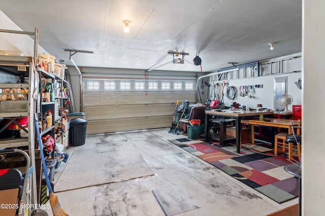 garage with a workshop area and a garage door opener