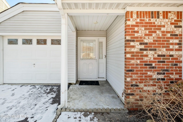 view of snow covered property entrance