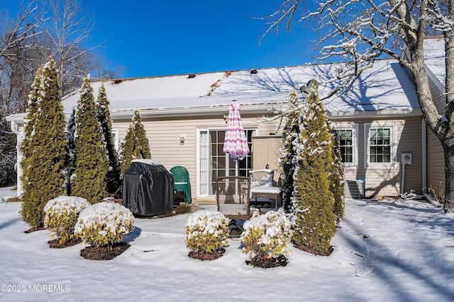 view of snow covered rear of property